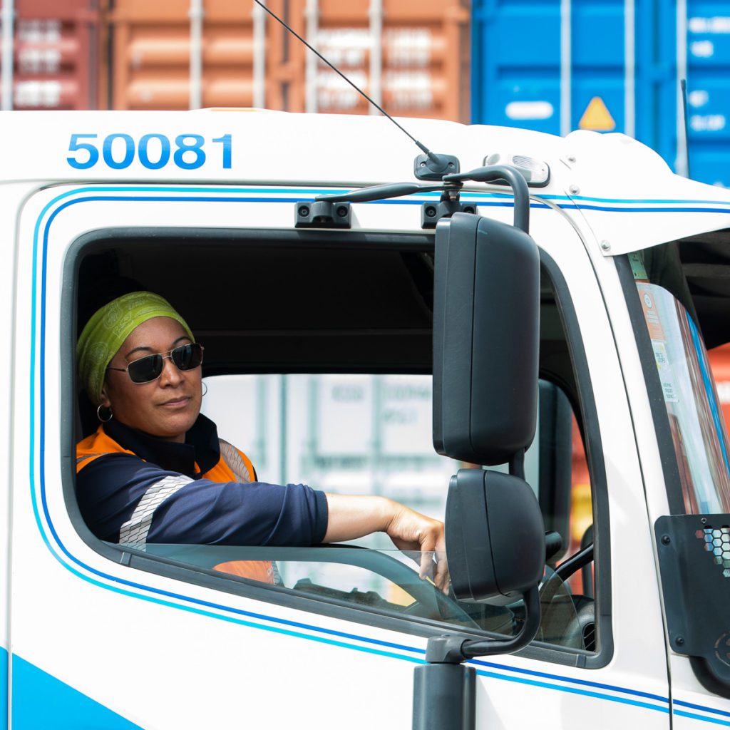 Female truck driver looking out window